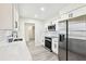 Modern kitchen with white cabinets, stainless steel appliances, and quartz countertops at 10904 90Th Ter, Seminole, FL 33772