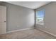 Well-lit bedroom with gray walls and carpet at 1107 Seminole Sky Dr, Ruskin, FL 33570