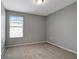 Simple bedroom with gray walls and carpet flooring at 1107 Seminole Sky Dr, Ruskin, FL 33570