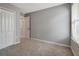 Bright bedroom featuring gray walls and carpet at 1107 Seminole Sky Dr, Ruskin, FL 33570