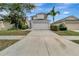 Two-story house with attached garage and landscaping at 1107 Seminole Sky Dr, Ruskin, FL 33570