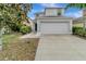 Two-story house with white siding, a two-car garage, and a landscaped yard at 1107 Seminole Sky Dr, Ruskin, FL 33570