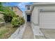 Landscaped front yard with walkway leading to the front door of the house at 1107 Seminole Sky Dr, Ruskin, FL 33570