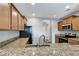 Granite countertop kitchen with stainless steel appliances and wood cabinets at 1107 Seminole Sky Dr, Ruskin, FL 33570