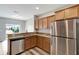 Modern kitchen with stainless steel appliances and granite countertops at 1107 Seminole Sky Dr, Ruskin, FL 33570