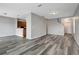Open living room with wood-look floors and a partial kitchen view at 1107 Seminole Sky Dr, Ruskin, FL 33570