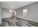 Spacious living room with gray walls, wood-look floors, and windows at 1107 Seminole Sky Dr, Ruskin, FL 33570