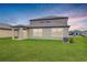 Landscaped backyard with a covered patio and AC unit at 11307 Linden Depot Rd, San Antonio, FL 33576