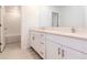 Bathroom with double vanity, white cabinets, and quartz countertops at 11307 Linden Depot Rd, San Antonio, FL 33576