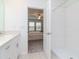 Bright bathroom with white cabinets, quartz countertops, and a shower/tub combo at 11307 Linden Depot Rd, San Antonio, FL 33576
