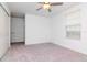 Bedroom with grey carpet, ceiling fan, double door closet and window at 11307 Linden Depot Rd, San Antonio, FL 33576