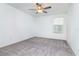 Simple bedroom with grey carpet, ceiling fan and window with blinds at 11307 Linden Depot Rd, San Antonio, FL 33576