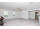 Bonus room with grey carpet, ceiling fan, and access to a bathroom at 11307 Linden Depot Rd, San Antonio, FL 33576
