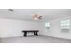 Spacious bonus room with grey carpet, ceiling fan, and large windows at 11307 Linden Depot Rd, San Antonio, FL 33576