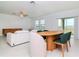 Dining area with wood table and modern chairs, overlooking the backyard at 11307 Linden Depot Rd, San Antonio, FL 33576