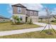 Two-story house with brown siding, beige garage door, and landscaping at 11307 Linden Depot Rd, San Antonio, FL 33576