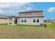 Two story house exterior with backyard and landscaping at 11307 Linden Depot Rd, San Antonio, FL 33576