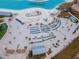 Aerial view of crystal lagoon with beach and lounge chairs at 11307 Linden Depot Rd, San Antonio, FL 33576