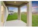 Covered patio overlooking a grassy backyard and lake at 11307 Linden Depot Rd, San Antonio, FL 33576