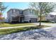 Two story house with gray siding, solar panels, and a two car garage at 11514 Brighton Knoll Loop, Riverview, FL 33579
