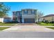 Two-story house with gray siding, solar panels, and a two-car garage at 11514 Brighton Knoll Loop, Riverview, FL 33579