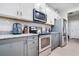 Modern kitchen with gray cabinets, granite countertops, and stainless steel appliances at 11514 Brighton Knoll Loop, Riverview, FL 33579