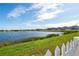 Scenic view of a lake with homes and lush grass at 11514 Brighton Knoll Loop, Riverview, FL 33579