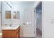 Full bathroom with wood vanity and shower/tub combo at 11814 Castine St, New Port Richey, FL 34654