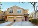 Two-story tan house with two-car garage and burgundy front door at 11814 Castine St, New Port Richey, FL 34654