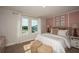 Bright bedroom with blush-toned decor and large windows at 12144 Cattleside Dr, Riverview, FL 33579