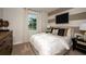 Charming bedroom with a stylish accent wall and comfortable bedding at 12144 Cattleside Dr, Riverview, FL 33579