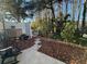 Landscaped backyard with patio, rocking chair, and wood-chip ground cover at 12411 Cavalier Ct, Hudson, FL 34669