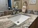 Bathroom with granite countertop and single sink vanity at 12411 Cavalier Ct, Hudson, FL 34669