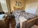 Bedroom with wood floors and a queen-size bed at 12411 Cavalier Ct, Hudson, FL 34669