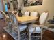 Elegant dining set with ornate chairs and light wood table at 12411 Cavalier Ct, Hudson, FL 34669