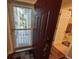 Inviting entryway with decorative doormat and view of a small patio at 12411 Cavalier Ct, Hudson, FL 34669