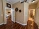 Bright hallway with wood floors and access to rooms at 12411 Cavalier Ct, Hudson, FL 34669