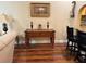 Living room features console table and hardwood floors at 12411 Cavalier Ct, Hudson, FL 34669