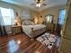 Main bedroom with king-size bed and hardwood floors at 12411 Cavalier Ct, Hudson, FL 34669