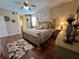 Spacious main bedroom with hardwood floors and large bed at 12411 Cavalier Ct, Hudson, FL 34669