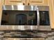 Stainless steel microwave installed above a stylish backsplash at 12411 Cavalier Ct, Hudson, FL 34669