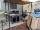 Outdoor patio with grill, storage unit, and gazebo at 12411 Cavalier Ct, Hudson, FL 34669