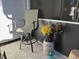 Small patio with chair, flowers, and decorative accents at 12411 Cavalier Ct, Hudson, FL 34669