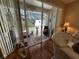 Bright sunroom with sliding glass doors leading to a patio at 12411 Cavalier Ct, Hudson, FL 34669