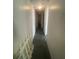 Long hallway with carpeted floors and doors to bedrooms at 12411 Eagle Lake Ave, New Port Richey, FL 34654