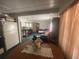 Kitchen with dining area and view into living room at 12411 Eagle Lake Ave, New Port Richey, FL 34654