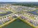 Wide aerial view of community with many houses and lakes at 12854 Boggy Creek Dr, Riverview, FL 33579