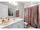 Bathroom with white vanity and artistic shower curtain at 12854 Boggy Creek Dr, Riverview, FL 33579