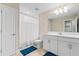 Bathroom with white vanity, mirror, and shower/tub combo at 12854 Boggy Creek Dr, Riverview, FL 33579