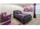 Spacious bedroom with plush bed and accent chairs at 12854 Boggy Creek Dr, Riverview, FL 33579